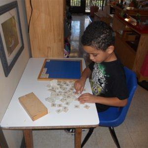 A boy learning to count at our Montessori school in Roseville, MN-4f7a5e5c5c
