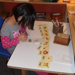 A girl learning how to match words at our Montessori school in Oakdale, MN-deaa2d87e9