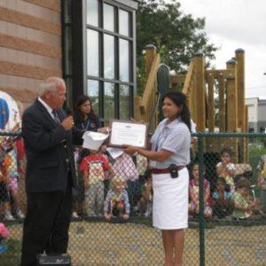 A woman presented with an award from Montessori school in Minneapolis, MN-50cf5d8b9c