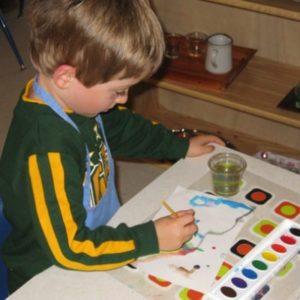 A young boy painting at our Montessori school in Oakdale, MN-fb688afff6