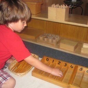 Child with spindle rods at our Montessori school in Oakdale, MN-265b58444f