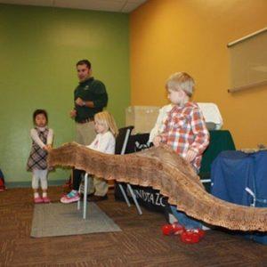 Children holding a snake skin at our Montessori school in Roseville, MN-07e7707dcc
