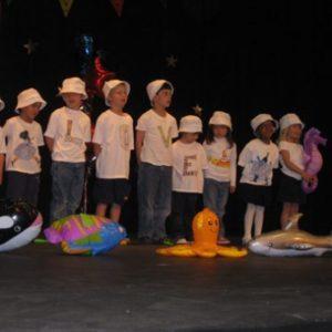 Children performing on stage at our Montessori school in Roseville, MN-9bc73b8386