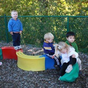 Four children playing on playground equipment at our Montessori school in Minneapolis, MN-8ff2404a02