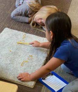 Kids Lying on Carpet and Painting Doodles — Minneapolis, MN — Miniapple International Montessori