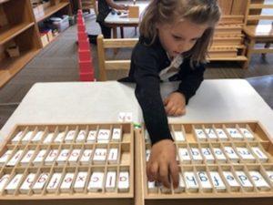 Little Girl Playing Word Game — Minneapolis, MN — Miniapple International Montessori
