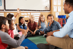Kids Sitting Around Teacher in a Lesson — Minneapolis, MN — Miniapple International Montessori