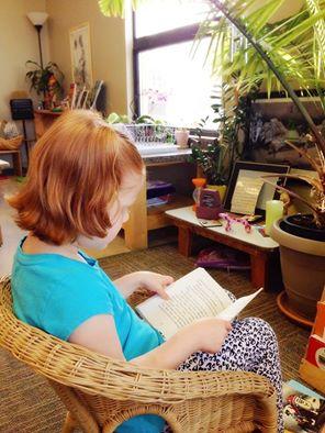 Little Girl Reading A Book — Minneapolis, MN — Miniapple International Montessori