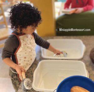 Cute Child Playing with Water — Minneapolis, MN — Miniapple International Montessori